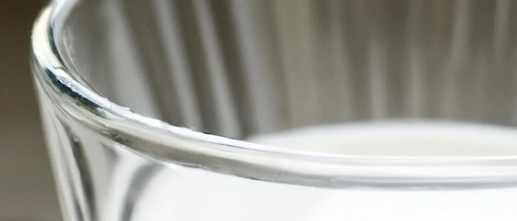Various barley milk cartons with diverse packaging on a wooden table