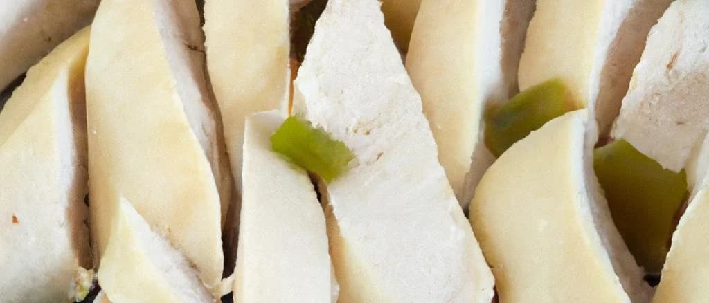 Reconstituted chicken breast slices on a wooden cutting board with herbs, packaging variations, white background