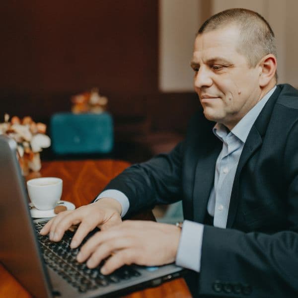 a man sitting in front of a laptop